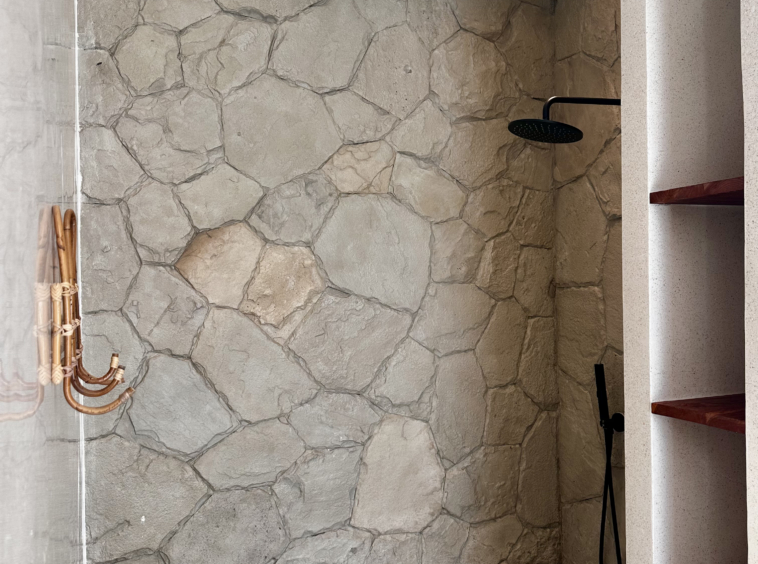 Real stone shower with terrazo wall