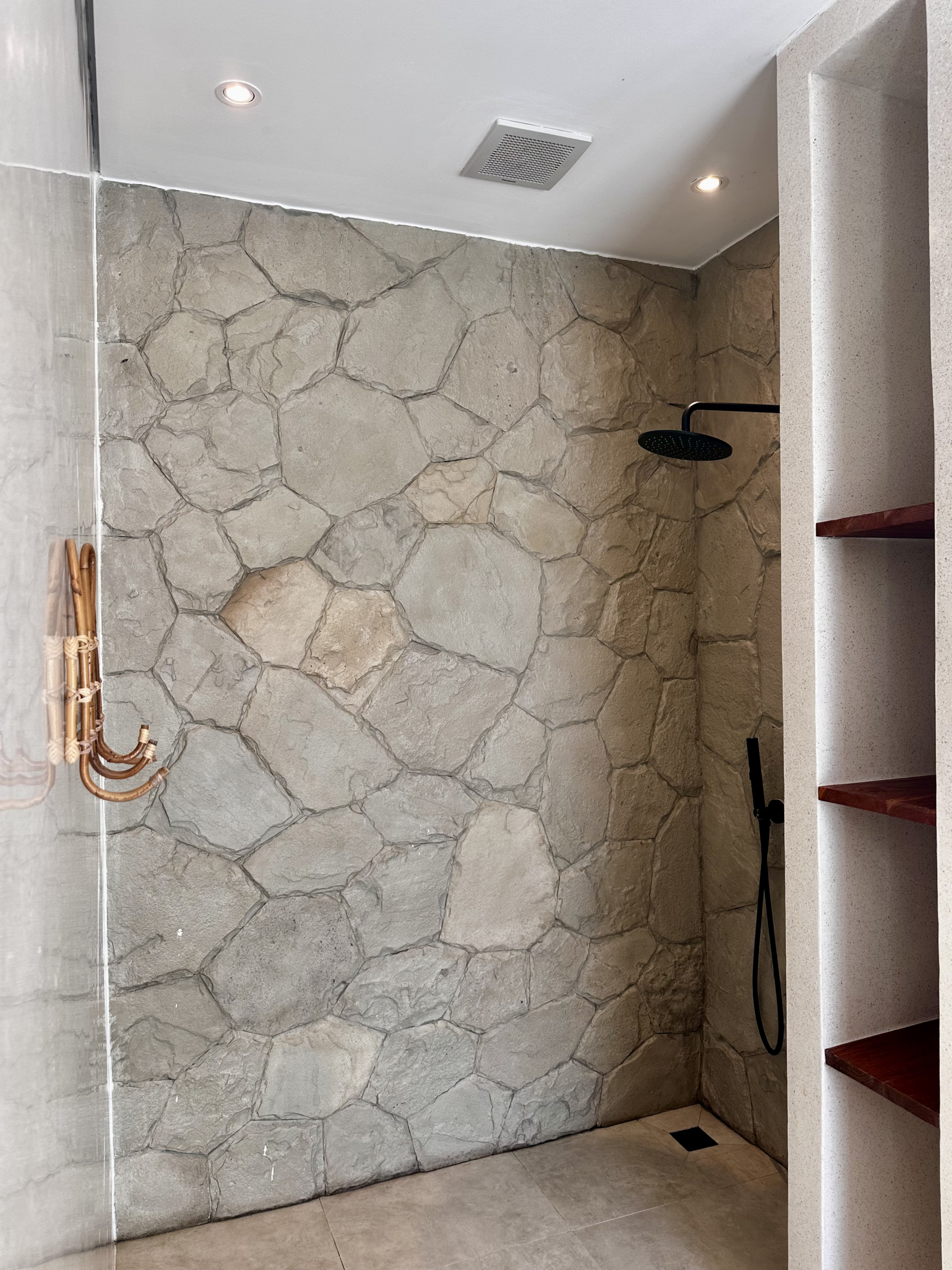 Real stone shower with terrazo wall