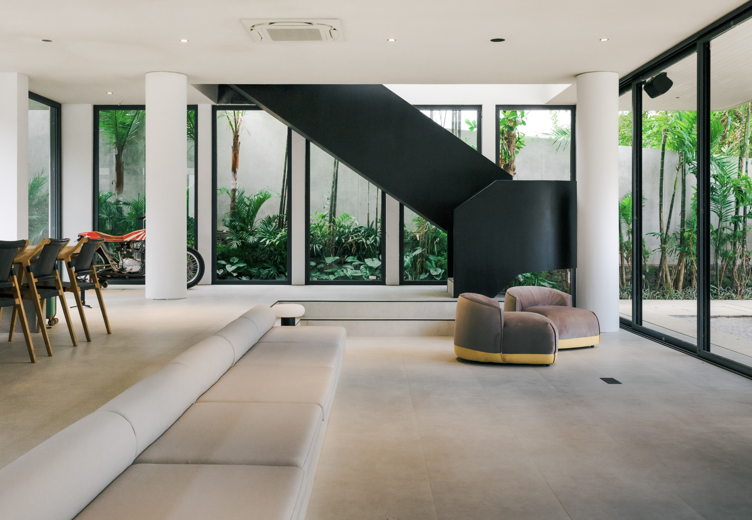 The modern stairs, long sofa, quality of the floor, motorbike in the corner.. Everythings is perfect in this villa