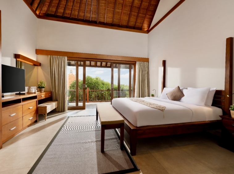 Wooden bed, wooden ceiling but luxurious tiles making this place the perfect place to stay in bali Canggu