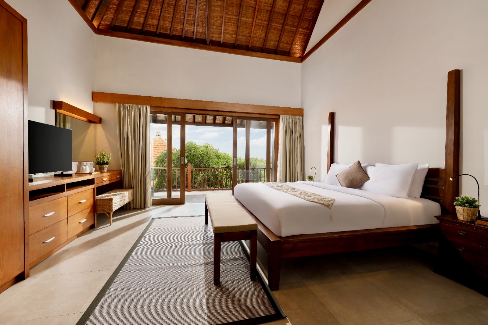 Wooden bed, wooden ceiling but luxurious tiles making this place the perfect place to stay in bali Canggu