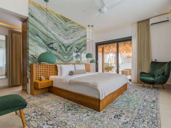Spacious master bedroom with green marble accent wall in Luxury 3 Bedrooms Villa in Prime Umalas