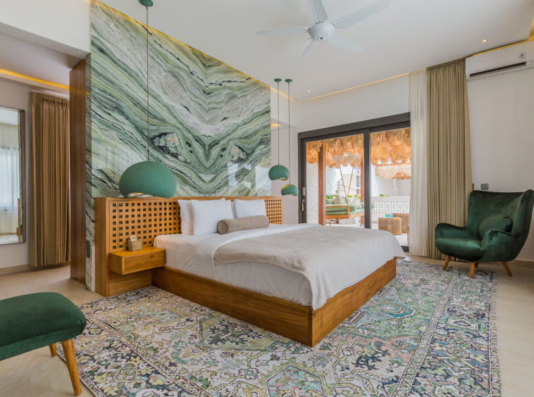 Spacious master bedroom with green marble accent wall in Luxury 3 Bedrooms Villa in Prime Umalas