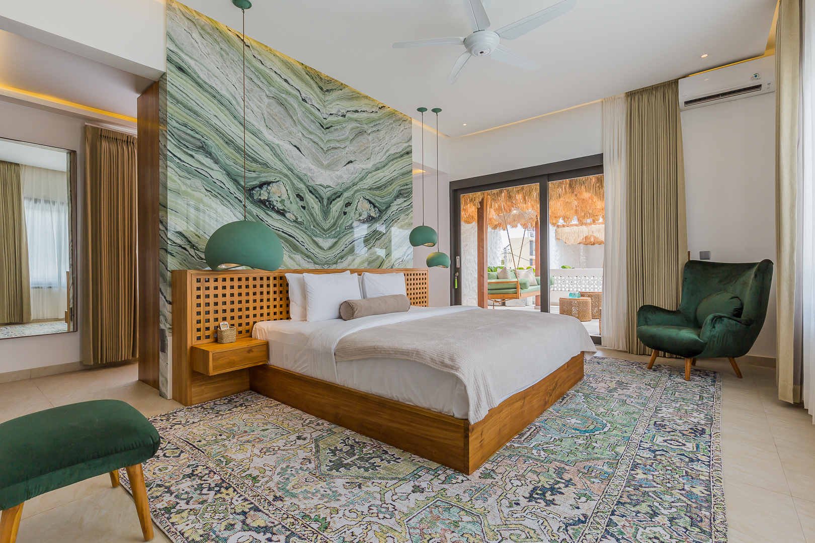 Spacious master bedroom with green marble accent wall in Luxury 3 Bedrooms Villa in Prime Umalas